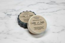 Load image into Gallery viewer, Cedar & Sage Shampoo Bar and Conditioner on a marble surface, featuring solid shampoo bar ingredients.