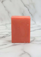 Load image into Gallery viewer, Scrubbly Bubbles buttermilk soap bar in peach color on a marble background.