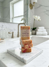 Load image into Gallery viewer, Stack of soap bars on a marble cutting board in a bathroom setting