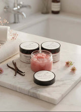 Load image into Gallery viewer, Vanilla Tallow Sugar Scrub showcased in jars on a marble countertop, highlighting its luxurious texture and natural ingredients.