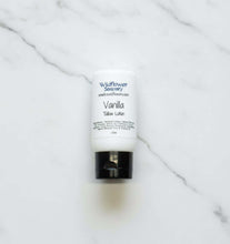 Load image into Gallery viewer, Wildflower Vanilla Tallow Lotion bottle on a marble surface, promoting hydration and skin nourishment.