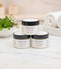 Load image into Gallery viewer, Three jars of Peppermint Tallow Sugar Scrub on a marble surface, surrounded by mint leaves and towels.