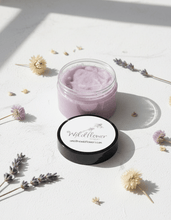 Load image into Gallery viewer, Luxury Lavender Sugar Scrub in a jar surrounded by dried flowers on a light background.