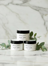 Load image into Gallery viewer, Two small cylindrical containers on a textured surface with a blurred background