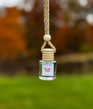 Load image into Gallery viewer, Harvest Apple Car Diffuser hanging in autumn scenery, delivering a warm fragrance for vehicles.