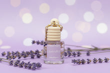 Load image into Gallery viewer, Lavender Hanging Car Diffuser beside dried lavender flowers on a purple background, promoting calm and soothing fragrance.