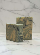 Load image into Gallery viewer, Two marbled soap bars on a marble surface