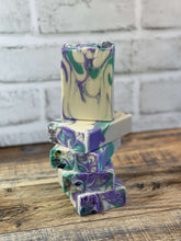 Load image into Gallery viewer, Spa Day Goat Milk Soap bars with vibrant purple and green swirls stacked on a rustic wooden surface.