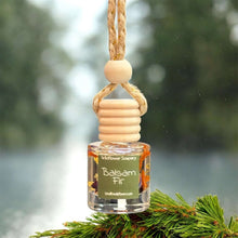 Load image into Gallery viewer, Balsam Fir Car Diffuser hanging from a tree branch, infusing your vehicle with fresh evergreen scents.