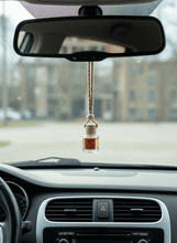 Load image into Gallery viewer, Spiced Tea car diffuser hanging from the rearview mirror, adding a cozy aroma to the vehicle.