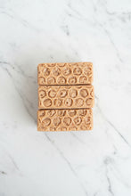 Load image into Gallery viewer, Three rectangular bars of honeycomb-patterned soap stacked vertically on a white marble surface.