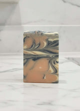 Load image into Gallery viewer, Guava Tea Goat Milk Soap bar with a marbled design on a marble surface.
