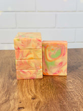 Load image into Gallery viewer, Colorful Splish Splash Tallow Soap bars with swirls of pink, orange, and green on a wooden surface.