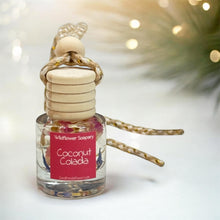 Load image into Gallery viewer, Coconut Colada car diffuser bottle with wooden cap and colorful design, promoting tropical scents for your car.