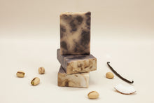 Load image into Gallery viewer, Buttermilk Soap Sandy Beach bars stacked with natural ingredients like pistachios and vanilla beans.

