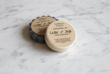 Load image into Gallery viewer, Cedar &amp; Sage Solid Conditioner Bar and solid shampoo on a marble countertop
