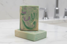 Load image into Gallery viewer, Tallow Goat Milk Soap - Rosemary with swirls of green and purple, resting on marble countertop.

