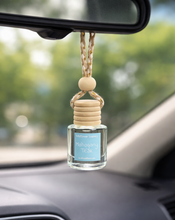 Load image into Gallery viewer, Car Diffuser hanging from car mirror with Mahogany Teak fragrance for a refined scent experience.
