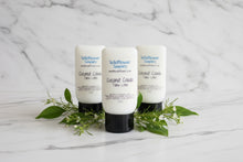 Load image into Gallery viewer, Three Coconut Colada Tallow Lotion bottles surrounded by greenery, featuring the focus keyword Hemp Lotion.
