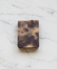 Load image into Gallery viewer, Buttermilk Soap Sandy Beach on a marble surface showcasing its creamy, marbled texture and luxurious appearance.
