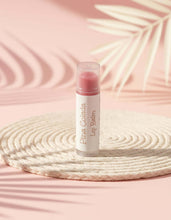 Load image into Gallery viewer, Piña Colada Lip Balm on a decorative mat, highlighting the smooth and moisturizing formula for soft lips.
