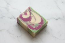 Load image into Gallery viewer, Agave Lime Goat Milk Soap bar with vibrant swirls of green, purple, and cream on a marble surface.
