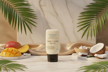 Load image into Gallery viewer, Lotion bottle labeled 'Mango &amp; Coconut Hemp Lotion' by Wildflower Soapary on a textured surface.
