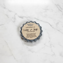 Load image into Gallery viewer, Cedar &amp; Sage Solid Shampoo Bar from Wildflower Soapary, showcasing the nourishing ingredients and unique shape.
