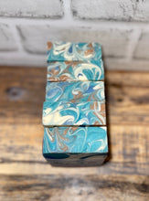 Load image into Gallery viewer, Swirly tops of bars of soap. White, blue &amp; tan swirl
