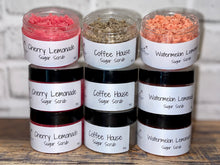 Load image into Gallery viewer, multiple containers of sugar scrub (pink, orange &amp; brown).
