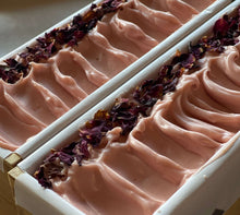 Load image into Gallery viewer, Light pink rose scented soap with rose pedals on top still in loaf mold
