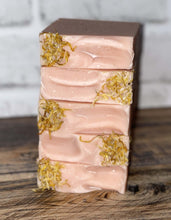 Load image into Gallery viewer, Light pink soap with yellow flower pedals on top stacked
